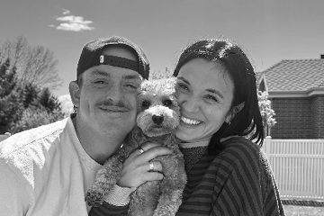 Tyler Chambers with a companion and a small dog, in a black-and-white photo